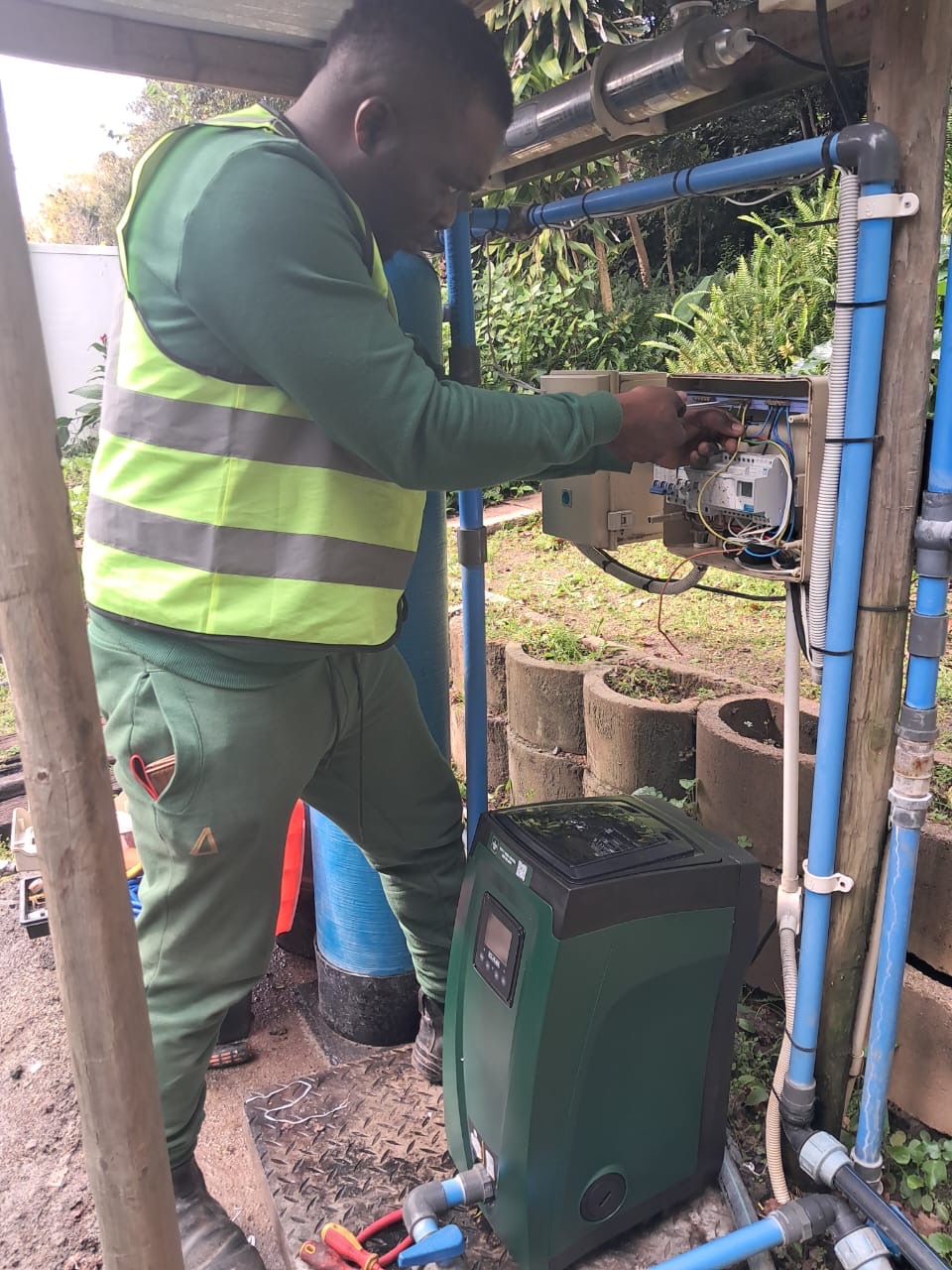 Steve wiring an irrigation pump's electrical control box